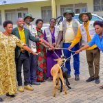 Agroup photo of ECOTRUST together with some local government officials handing over 2 improved goats to one of the model farmers awarded